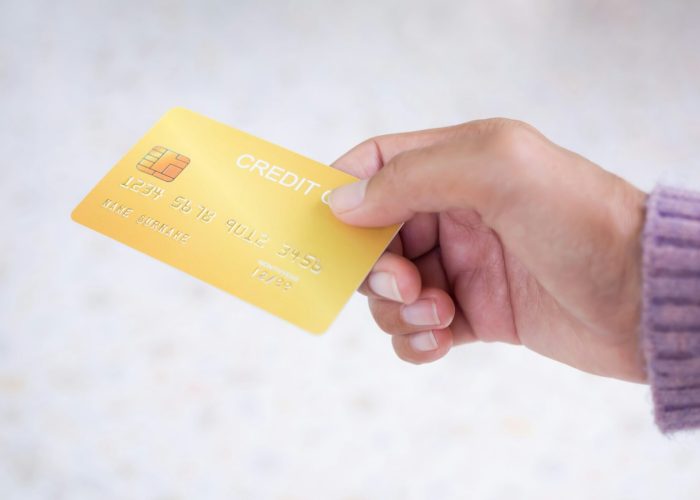 Hand woman with sweater holding credit card